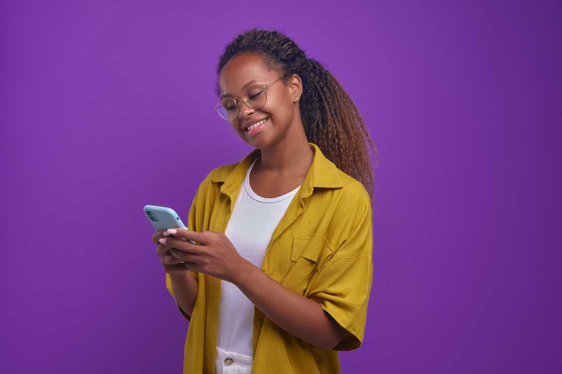 A woman using a phone. A woman using a phone.