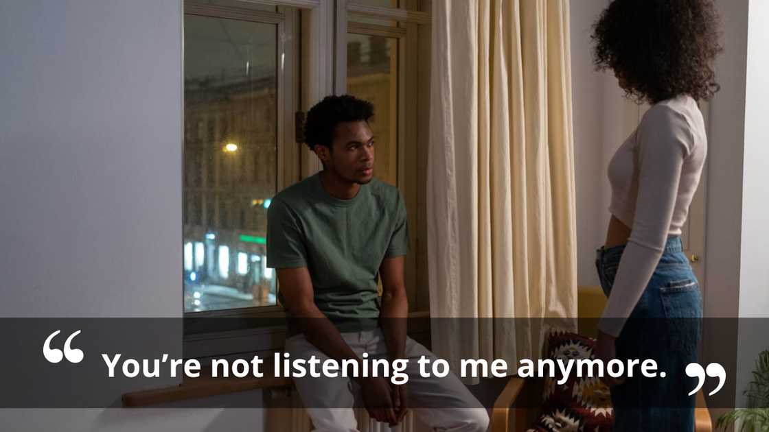 Two people having a tense conversation indoors at night.