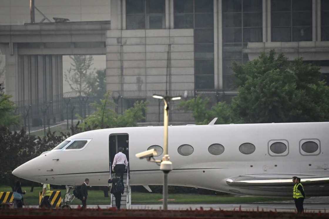 Tesla chief Elon Musk (in white) boards his private jet before departing Beijing Capital International Airport on May 31 Tesla chief Elon Musk (in white) boards his private jet before departing Beijing Capital International Airport on May 31