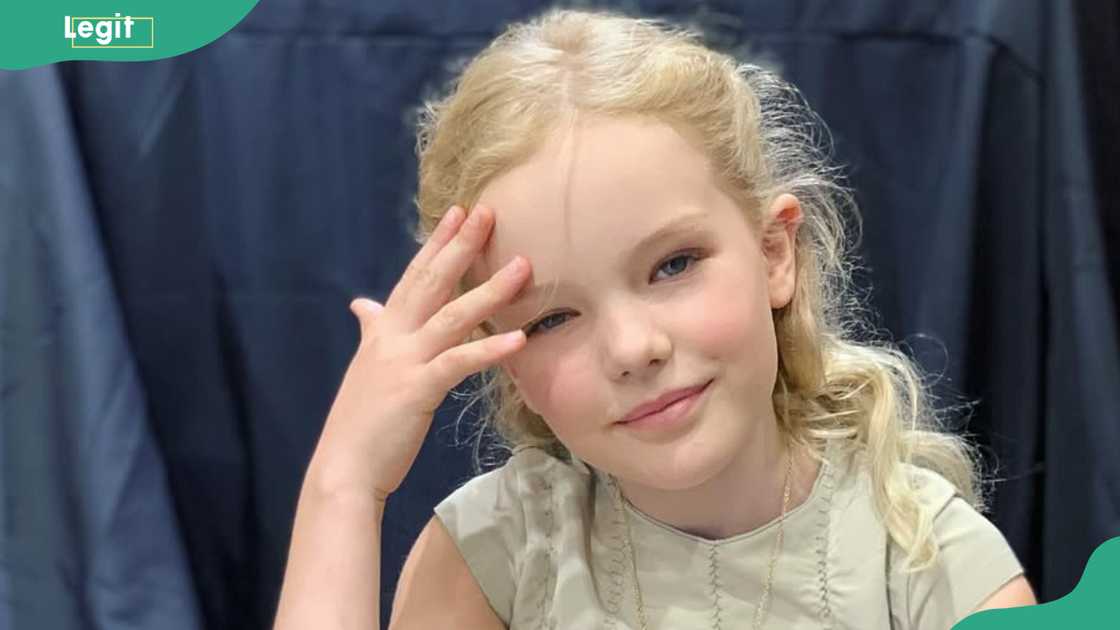 Olivia Van Der Beek smiles in a solo photo
