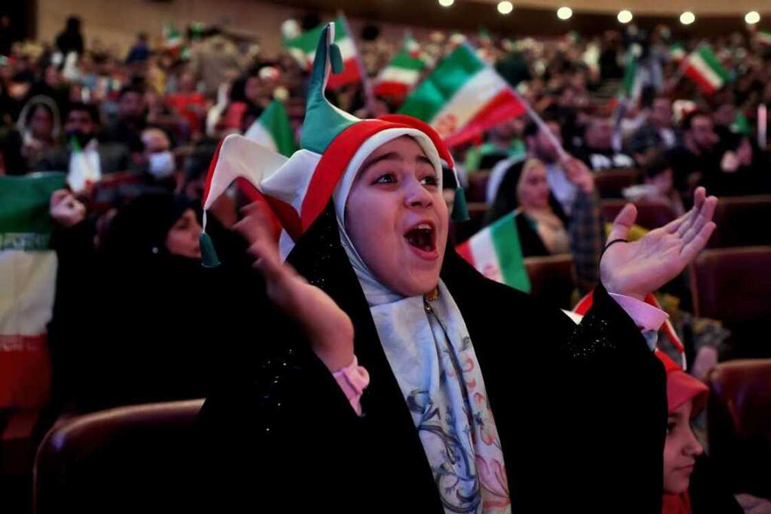 Men and women -- the latter wearing veils -- watched the game together in Milad Tower Hall in Tehran, in an unusual spectacle in a country where women have had difficulty accessing stadia Men and women -- the latter wearing veils -- watched the game together in Milad Tower Hall in Tehran, in an unusual spectacle in a country where women have had difficulty accessing stadia