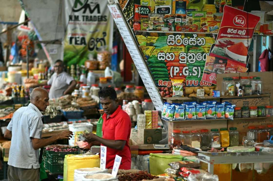 A man buys groceries at a market in Colombo A man buys groceries at a market in Colombo
