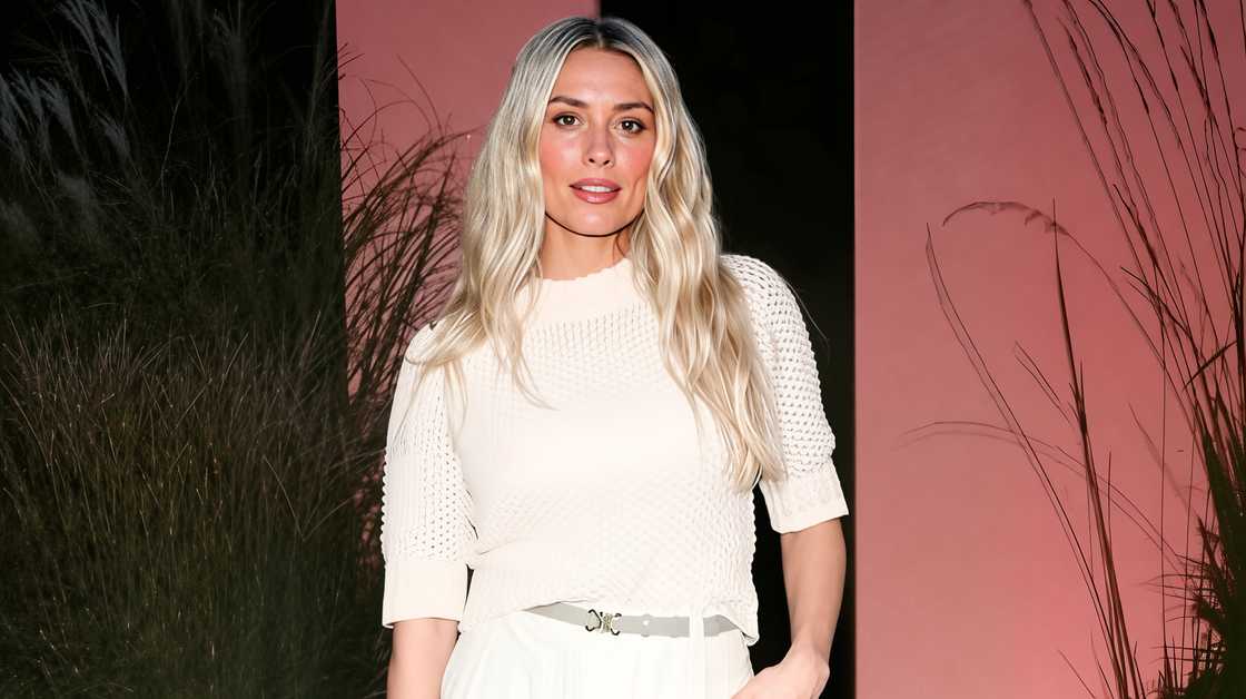 Arielle Vandenberg poses standing in a white outfit. Arielle Vandenberg poses standing in a white outfit.