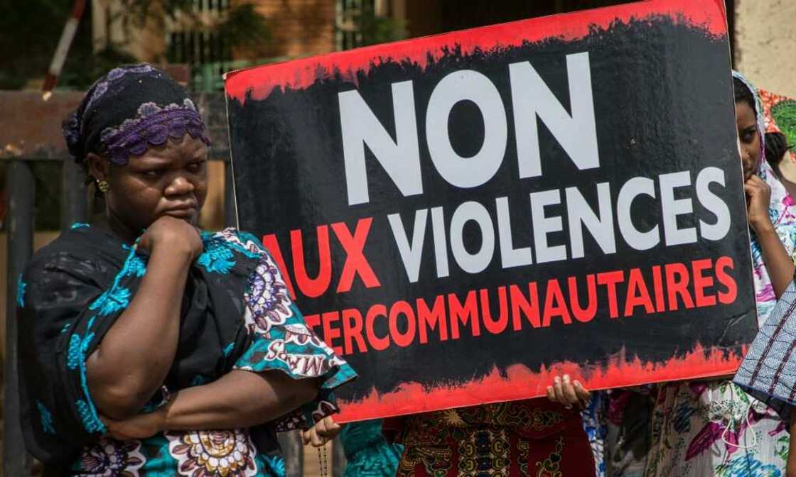 Women hold a sign reading 'No to intercommunity violence' after Fulani villagers in northern Burkina Faso were massacred in 2019 reprisal for a jihadist attack Women hold a sign reading 'No to intercommunity violence' after Fulani villagers in northern Burkina Faso were massacred in 2019 reprisal for a jihadist attack