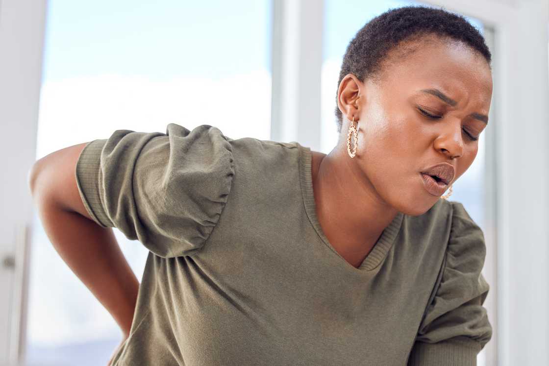 A woman experiences back pain