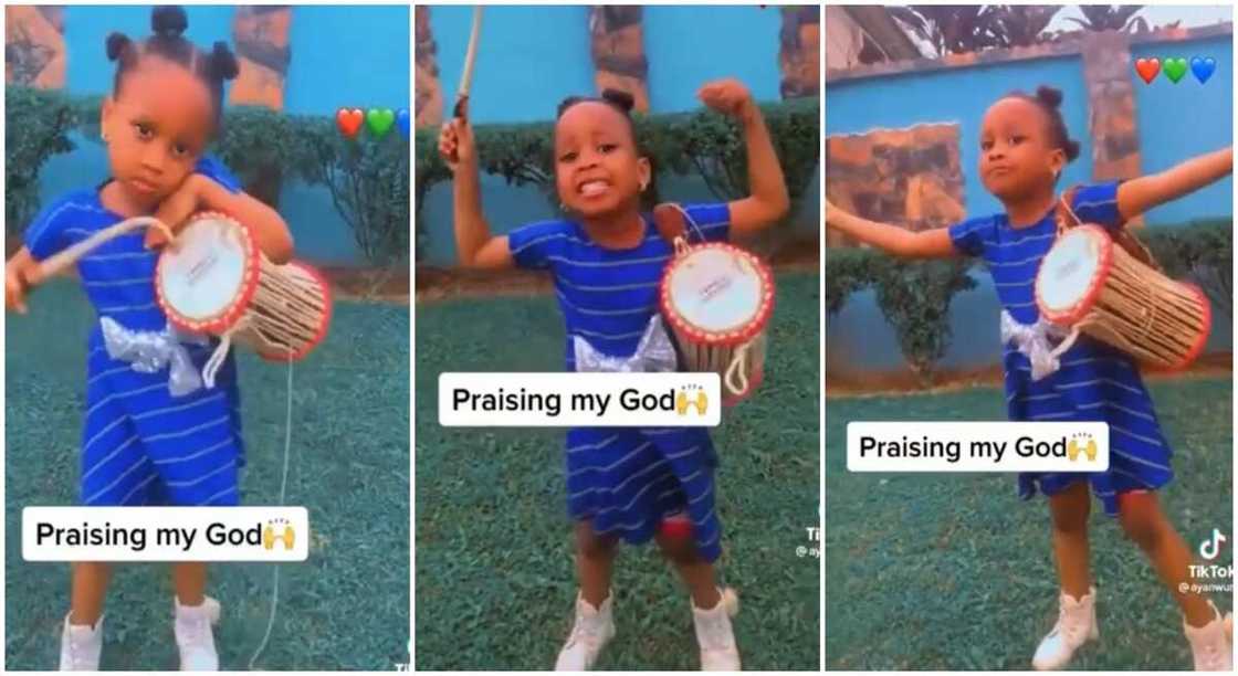 Photos of baby girl standing with Yoruba talking drum.