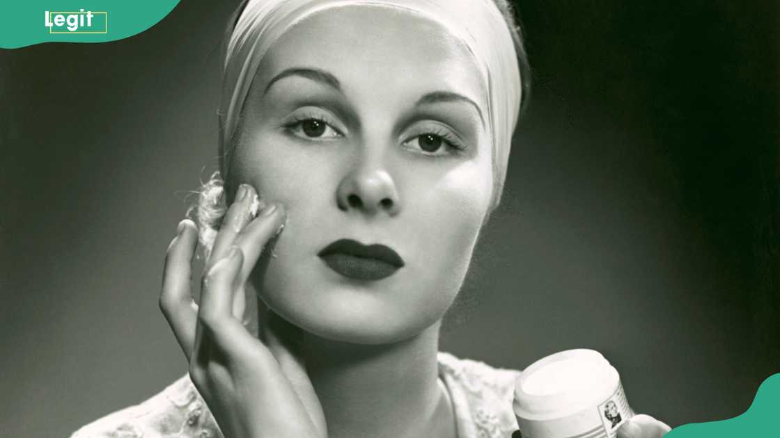 Woman applies face cream Woman applies face cream