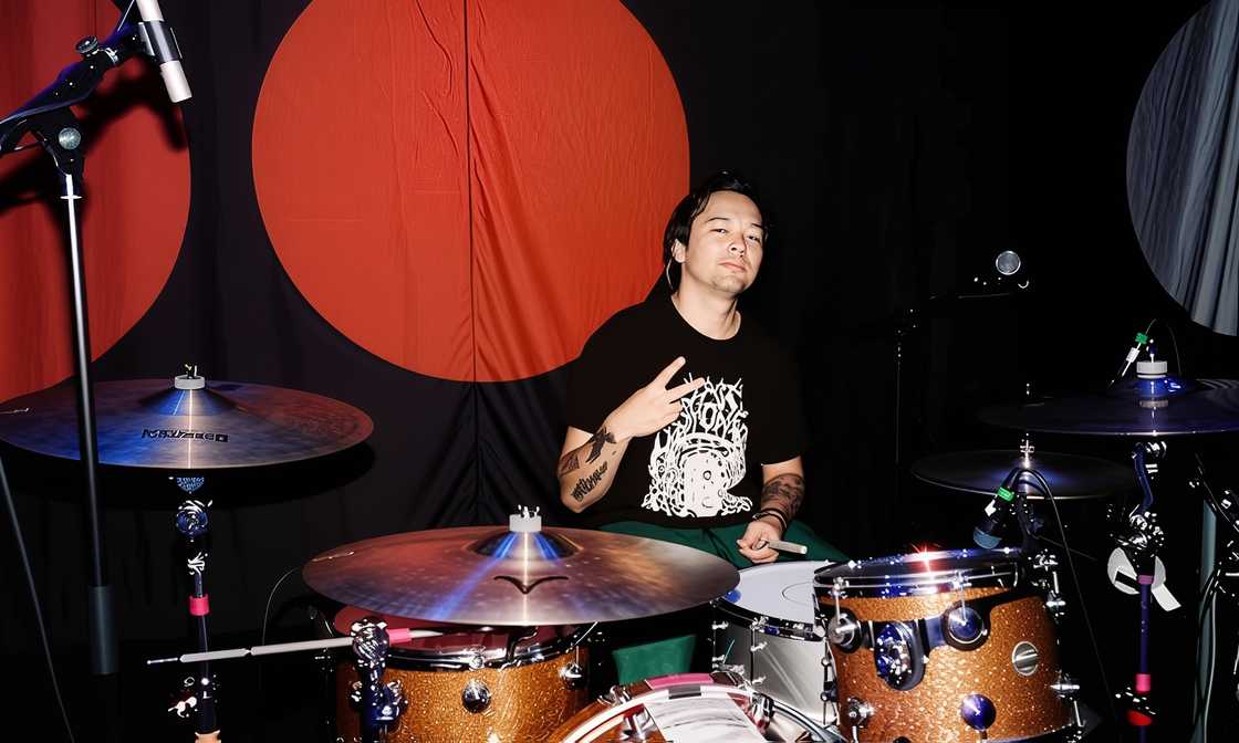 Elijah Hendrix Wahlberg seated behind a drum set in what appears to be a studio or live performance space.