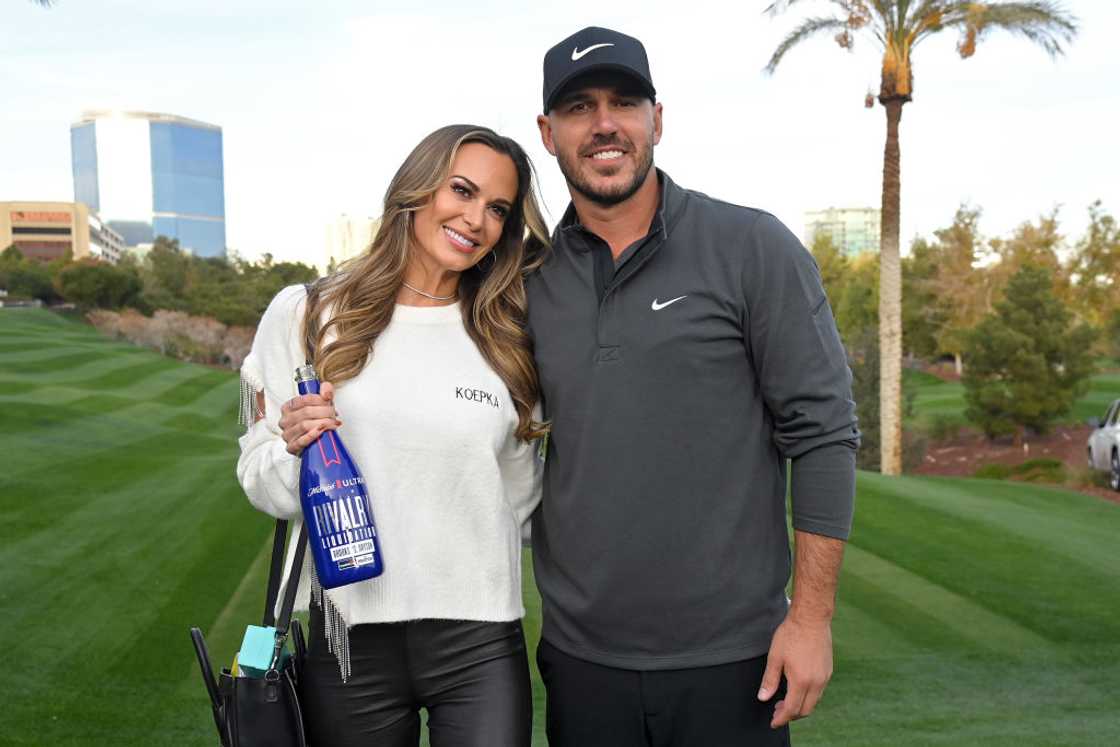 Brooks Koepka and Jena Sims pose for a photo on the golf course