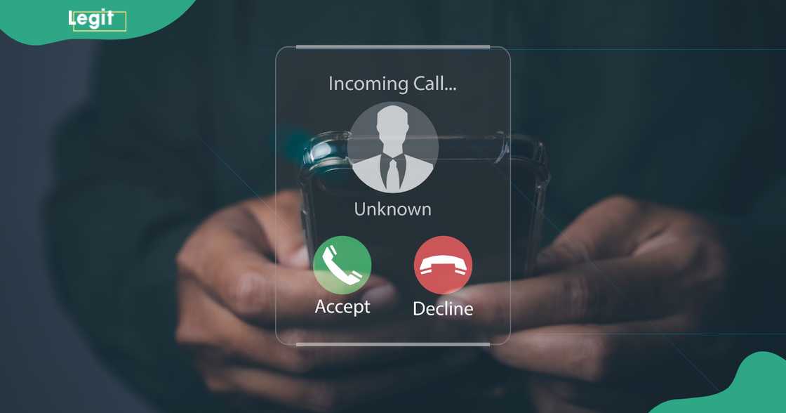 A man holds a phone as it rings. A man holds a phone as it rings.