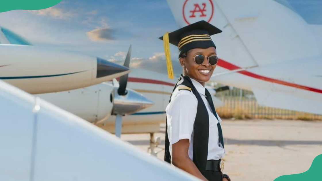 A young female pilot smiles as she gets out of a plane A young female pilot smiles as she gets out of a plane