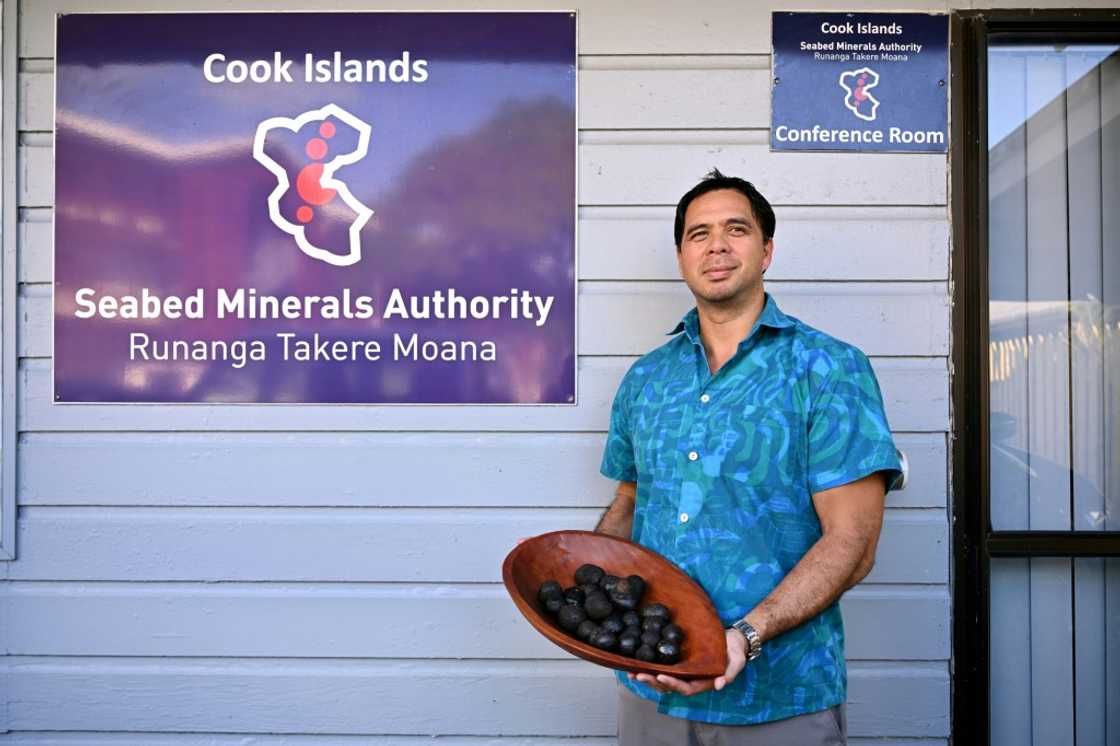 Edward Herman from the Cook Islands' Seabed Minerals Authority holds polymetallic nodules, misshapen black globes encrusted with cobalt, nickel, manganese and other coveted metals in Rarotonga Edward Herman from the Cook Islands' Seabed Minerals Authority holds polymetallic nodules, misshapen black globes encrusted with cobalt, nickel, manganese and other coveted metals in Rarotonga