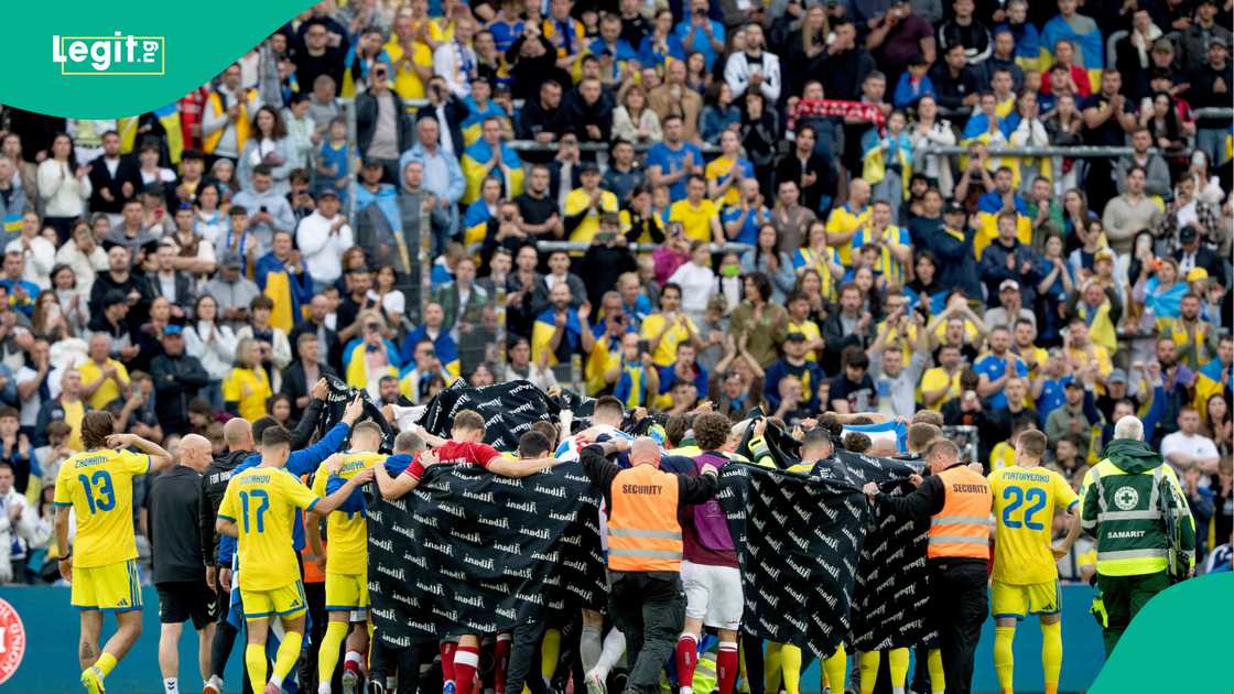 Denmark's and Ukraine's players accompany Christian Eriksen to a waiting ambulance on June 7, 2026. Photo by Ritzau Scanpix Denmark's and Ukraine's players accompany Christian Eriksen to a waiting ambulance on June 7, 2026. Photo by Ritzau Scanpix