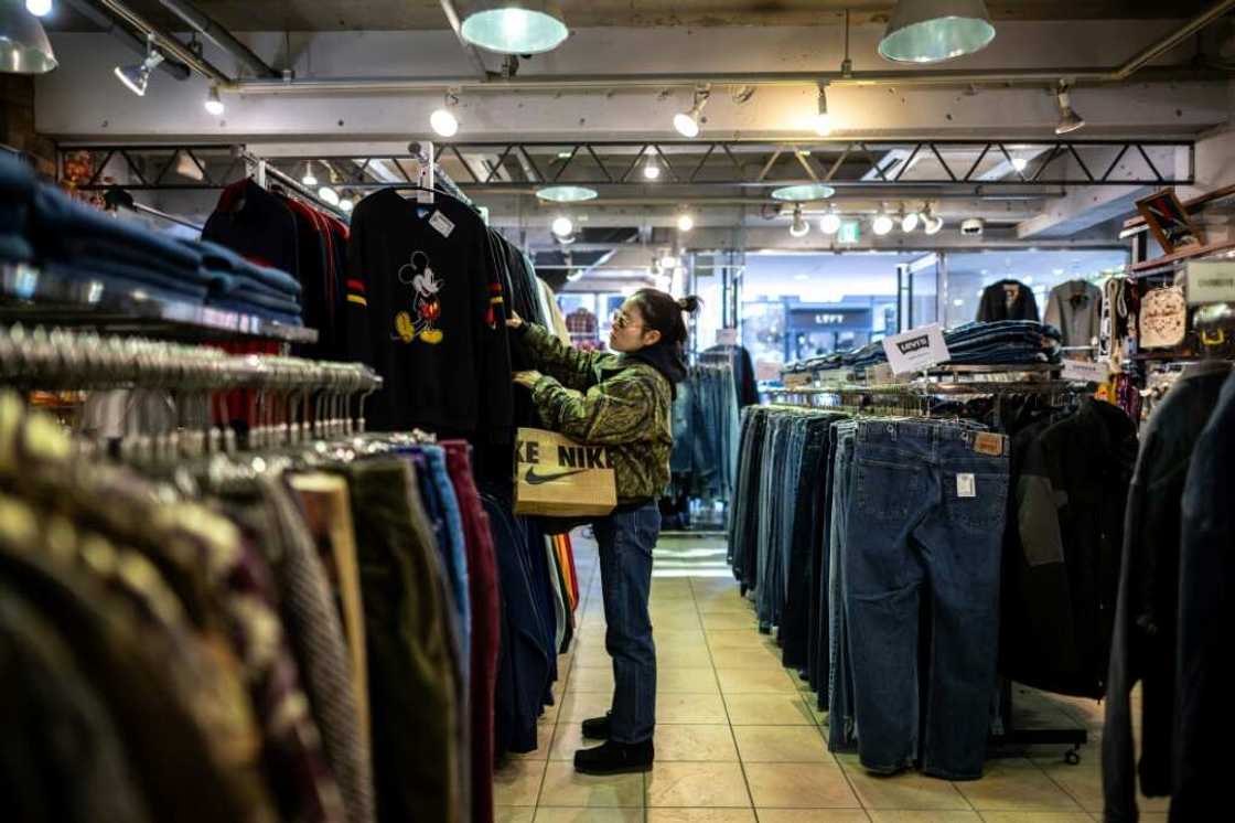 A customer visits a secondhand clothes shop in the Harajuku district of Tokyo