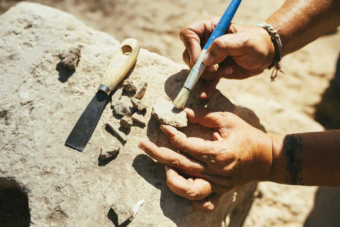 A geologist analysing some rocks A geologist analysing some rocks