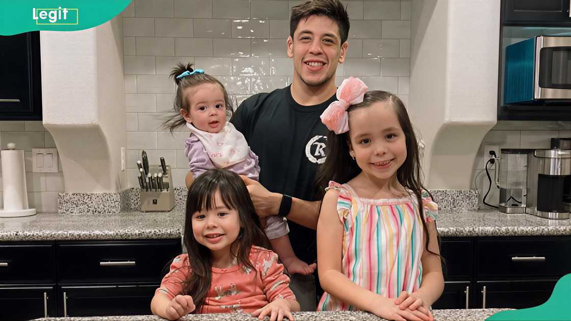 Brandon Moreno with his daughters in the kitchen