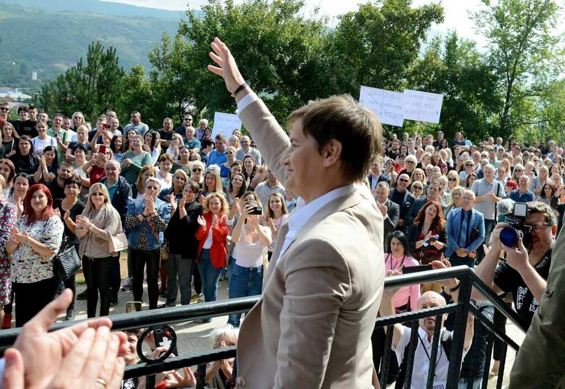 Serbia's Prime Minister Ana Brnabic waves to gathered local Serbs in the ethnically divided city of Mitrovica