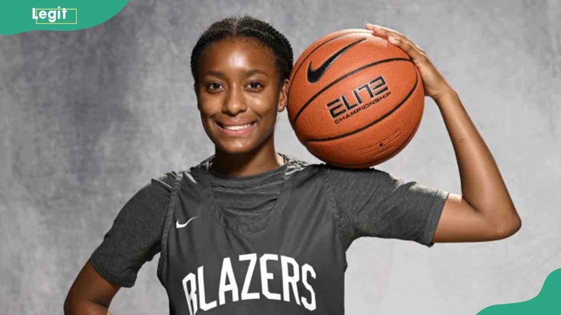 Gilbert's daughter, Izela, holding a basketball