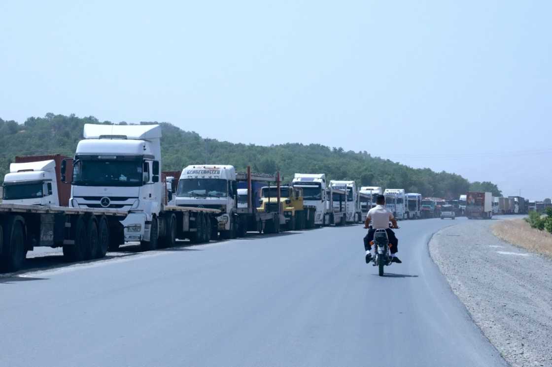 Trucks queue at the Bashmakh border crossing in Iraq, where some Iranian drivers described shortages of staple goods back home Trucks queue at the Bashmakh border crossing in Iraq, where some Iranian drivers described shortages of staple goods back home
