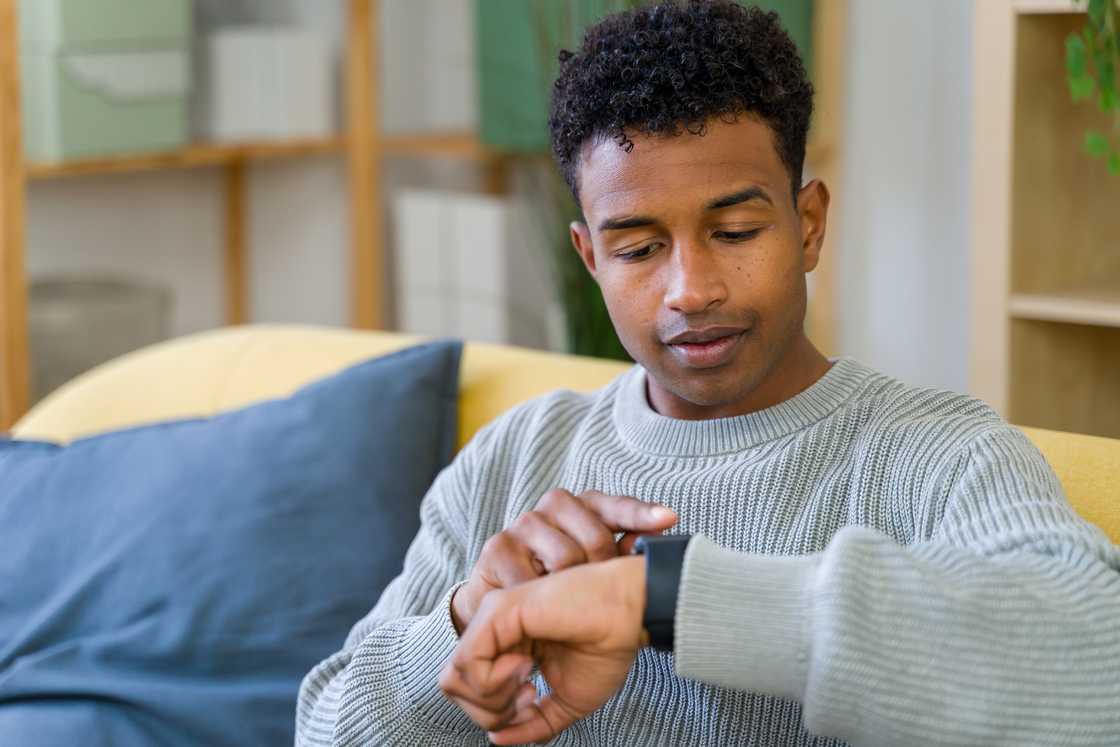 A young man is checking the time A young man is checking the time