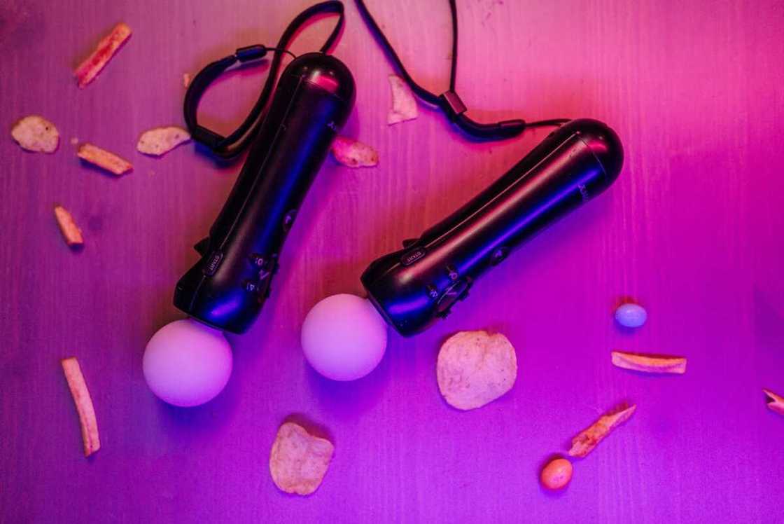 Playing gadget on a purple surface with snacks Playing gadget on a purple surface with snacks