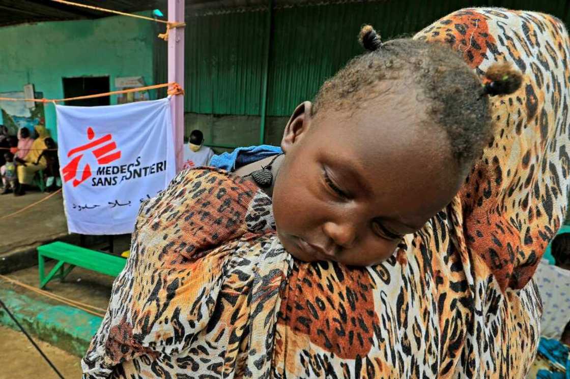 A family who fled clashes in Sudan's Blue Nile state last month wait at a clinic set up by health authorities in collaboration with Medecins Sans Frontieres