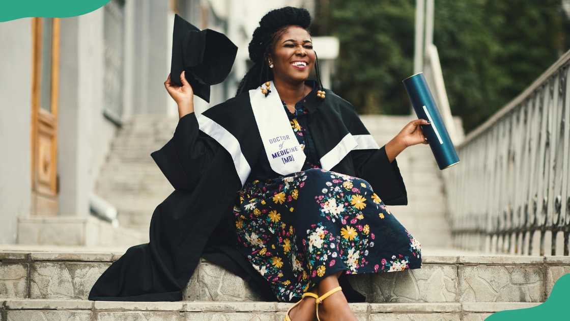 A lady smiles while celebrating her graduation A lady smiles while celebrating her graduation