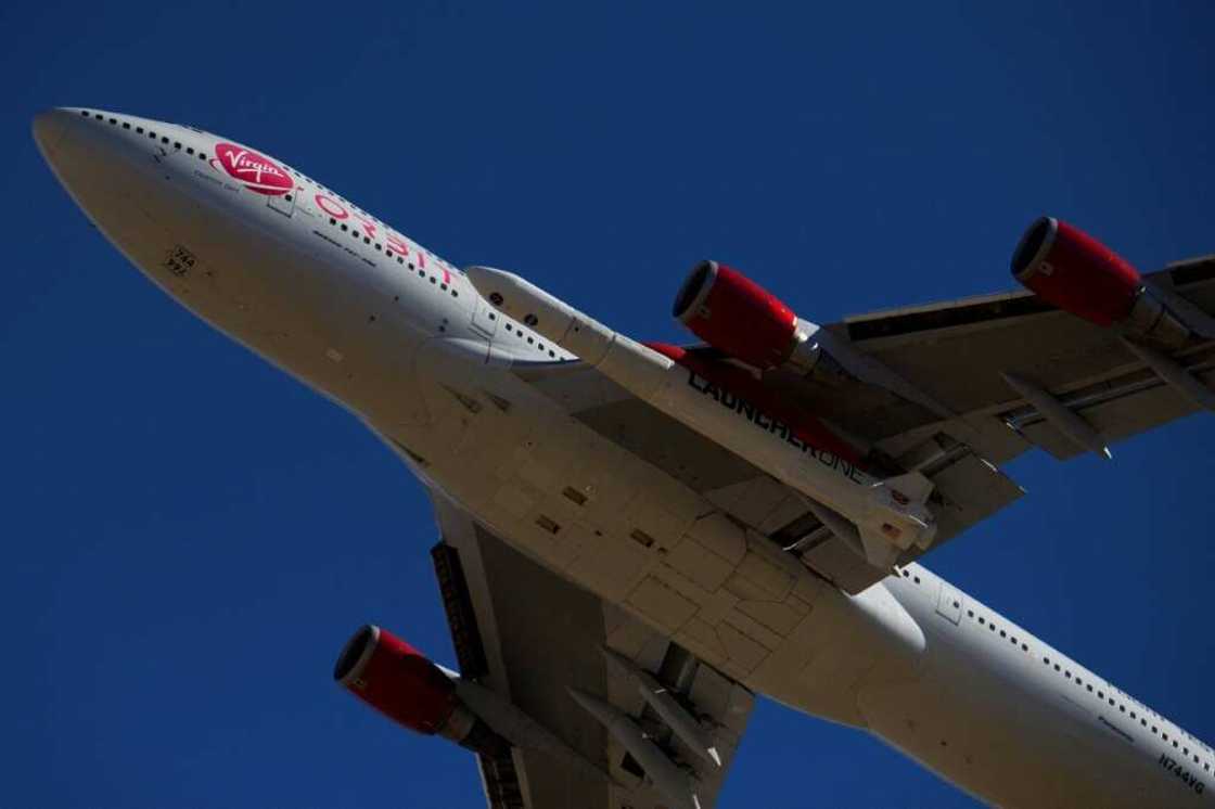 The Virgin Orbit 'Cosmic Girl' -- a modified Boeing 747 carrying a LauncherOne rocket under its wing -- takes off from Mojave Air and Space Port in 2021