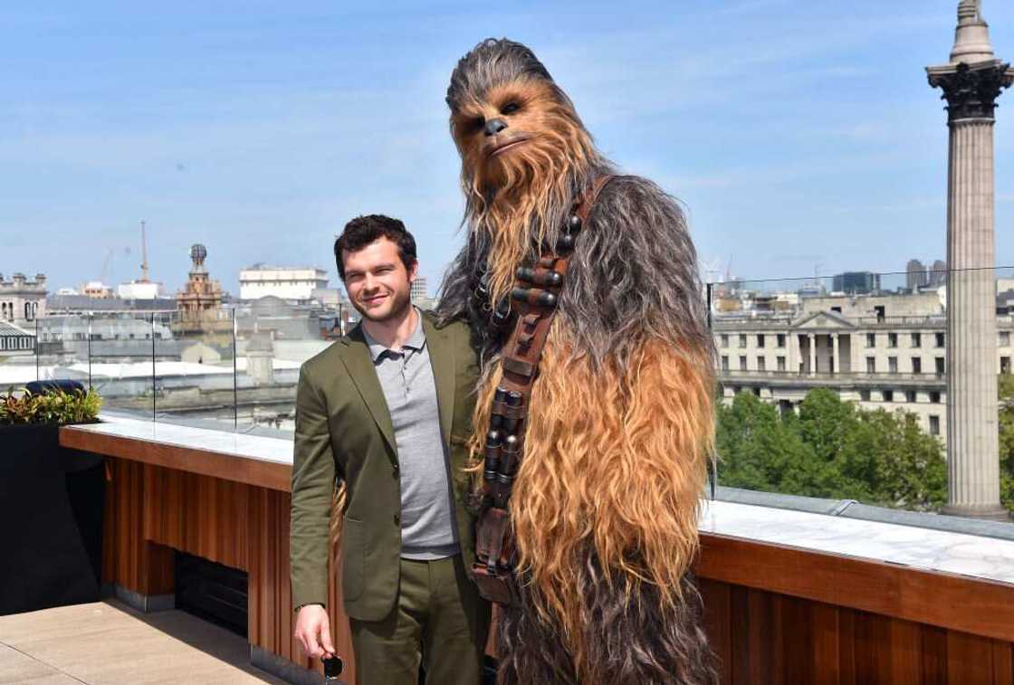 Alden Ehrenreich and Chewbacca attend a photocall