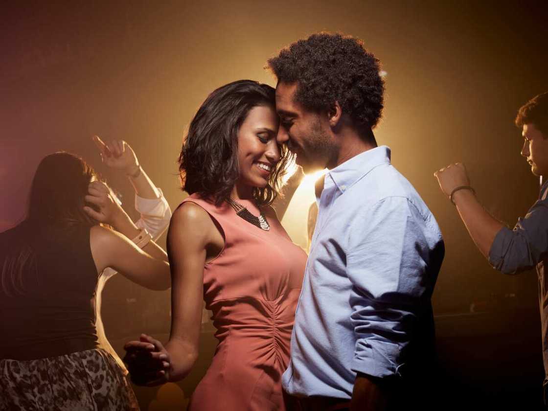 A young couple dancing at a nightclub