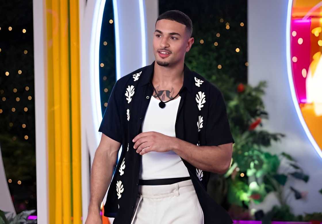 Miguel Harichi in black and white walking into the Casa Amor Miguel Harichi in black and white walking into the Casa Amor