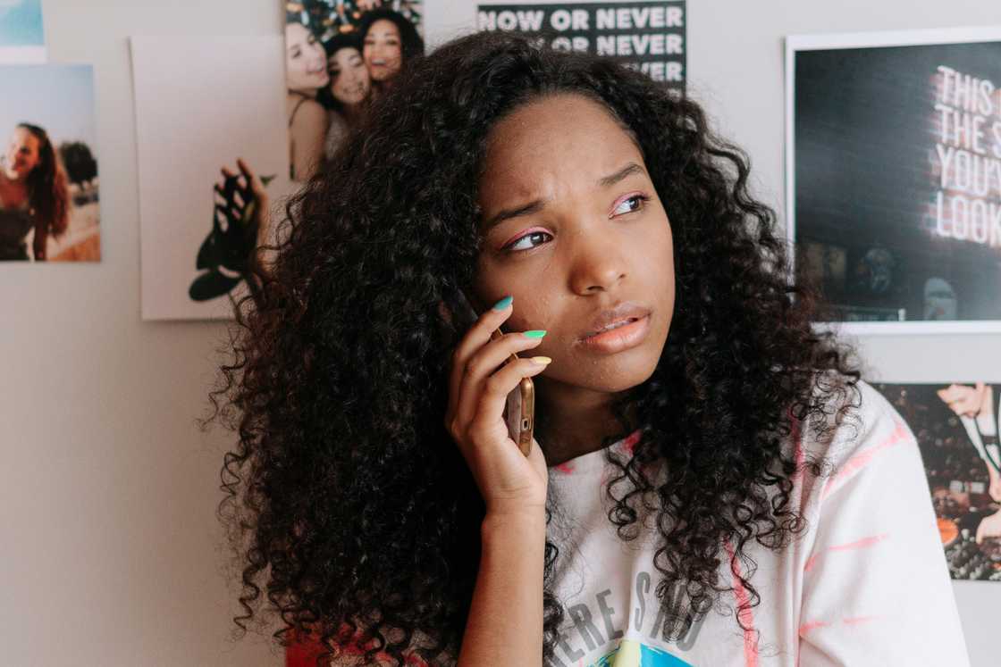 A girl is talking on the phone A girl is talking on the phone