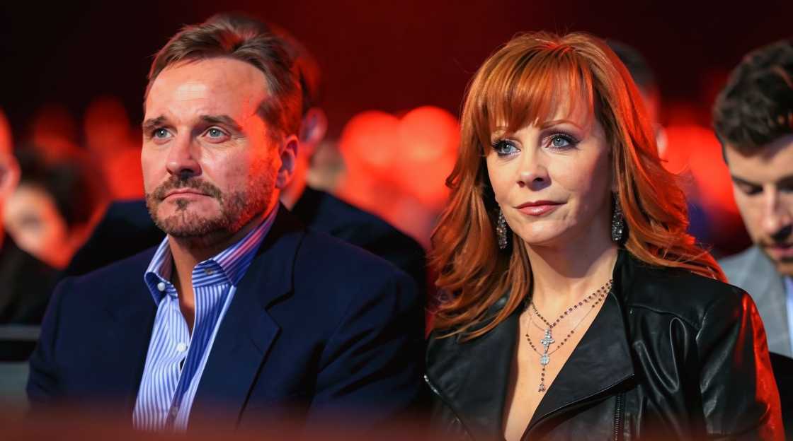 Reba McEntire and Narvel Blackstock sit next to each other at an event together. Reba McEntire and Narvel Blackstock sit next to each other at an event together.