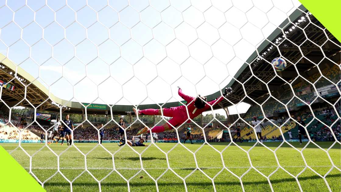 Jennifer Echegini scores past Japanese goalkeeper Ayaka Yamashita.