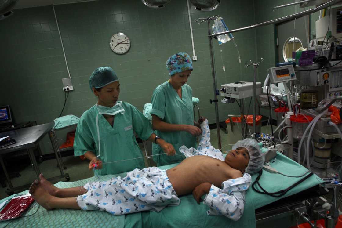 A boy is being operated upon in the theatre