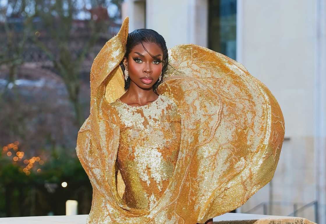 Olandria Carthen poses in a golden dress