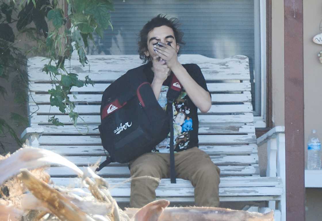 Tylor Chase smoking on a porch. Tylor Chase smoking on a porch.