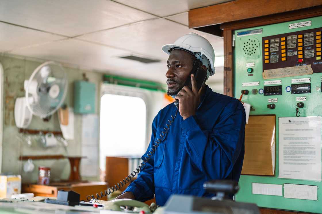 A male engineer in blue coveralls.
