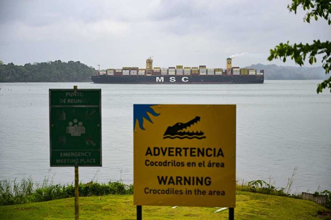 A cargo ship passes through the Panama Canal A cargo ship passes through the Panama Canal