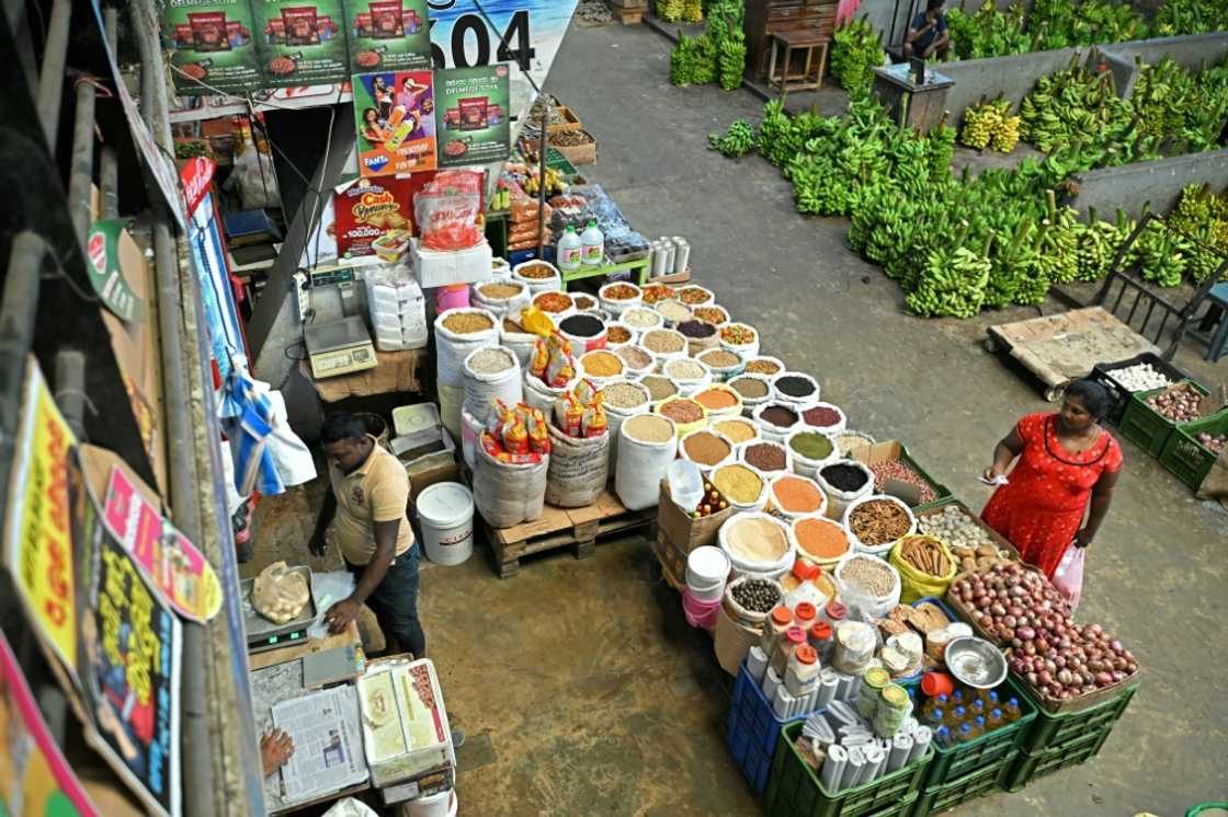 A woman buys groceries at a market in Colombo A woman buys groceries at a market in Colombo