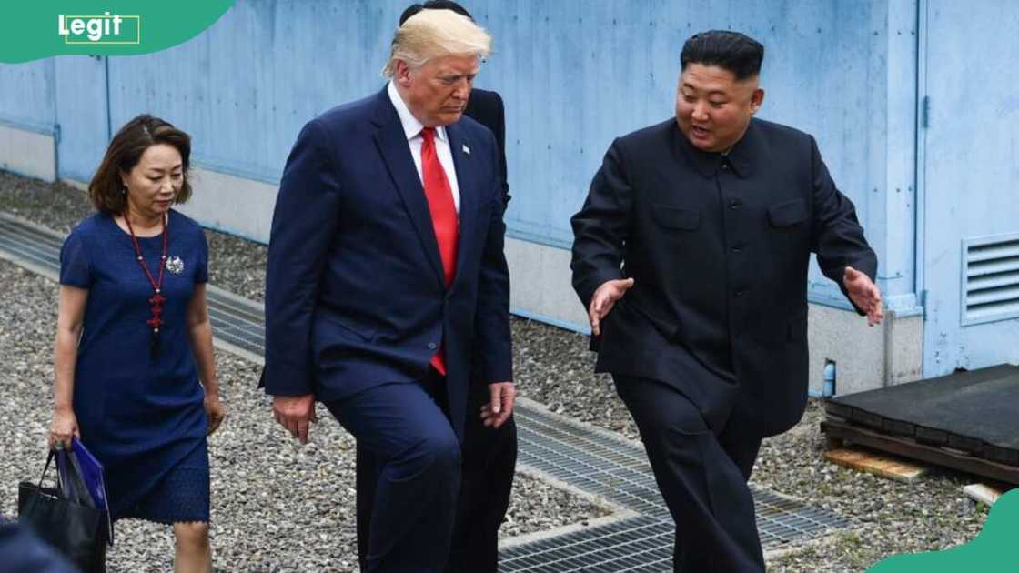 Kim Sol- song carrying a folder and bag behind Donald Trump and Kim Jong-un Kim Sol- song carrying a folder and bag behind Donald Trump and Kim Jong-un