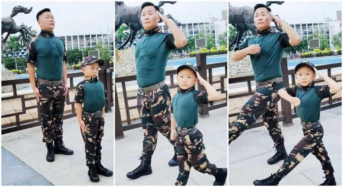 Boy and adult in military fatique performs march past.