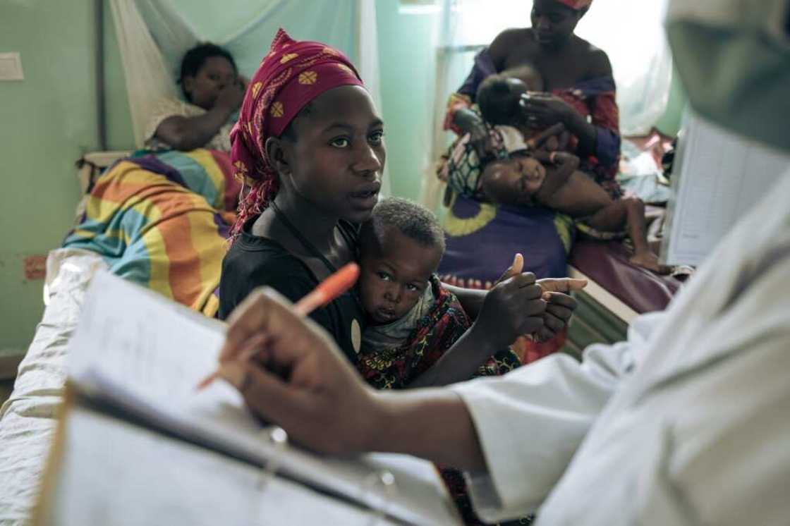 A mother with her malnourished child speaks with a doctor at Rutshuru Hospital A mother with her malnourished child speaks with a doctor at Rutshuru Hospital