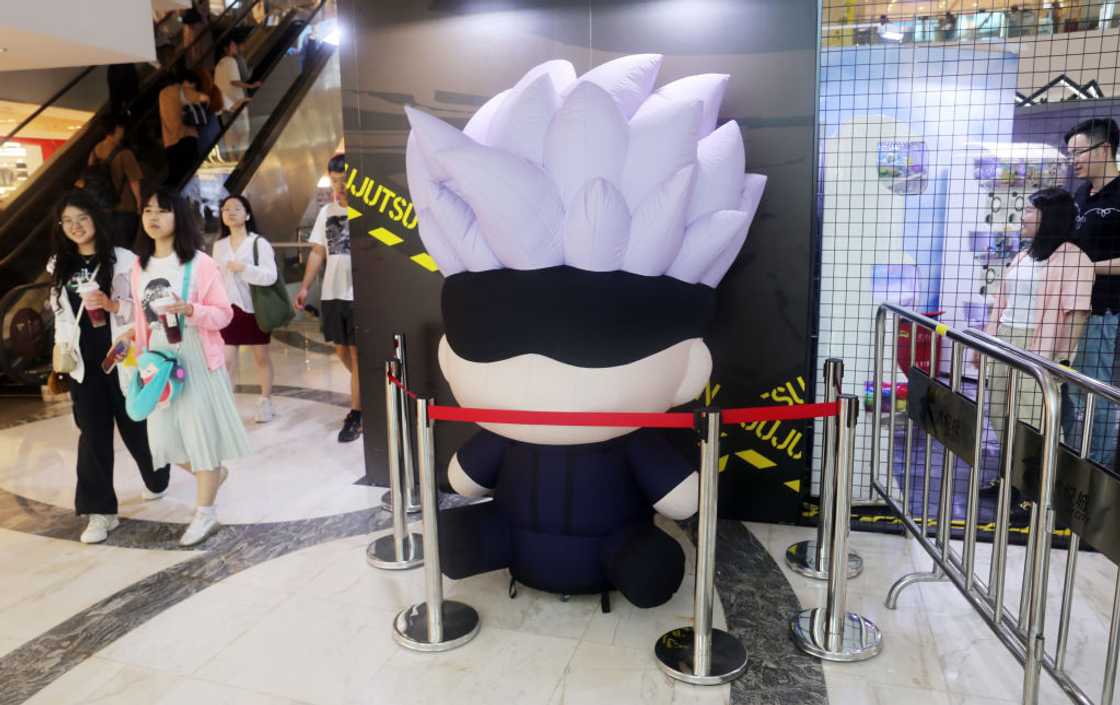 A giant inflatable Satoru Gojo figure with white hair and a blindfold at a Jujutsu Kaisen pop-up shop in Shanghai, 2024
