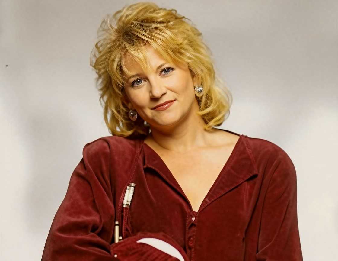 Betsy Smittle poses holding a red bass guitar Betsy Smittle poses holding a red bass guitar