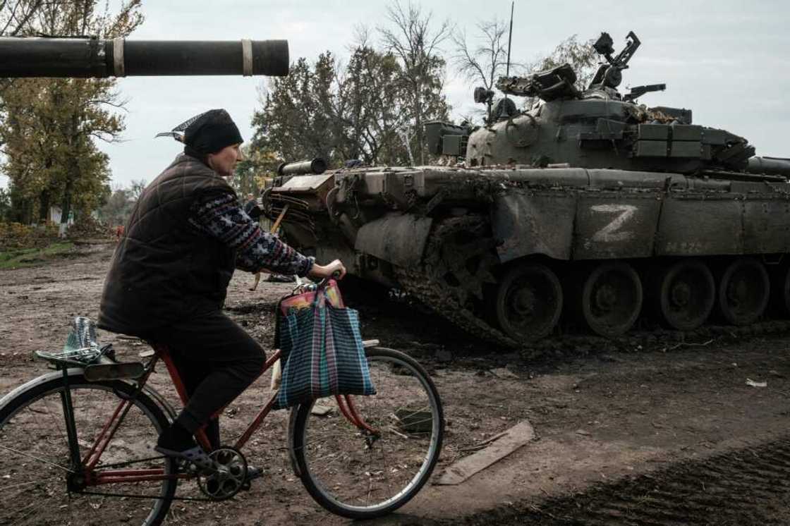 A local resident rides past an abandoned Russian tank marked Z near Kharkiv in Ukraine on September 30, 2022 A local resident rides past an abandoned Russian tank marked Z near Kharkiv in Ukraine on September 30, 2022