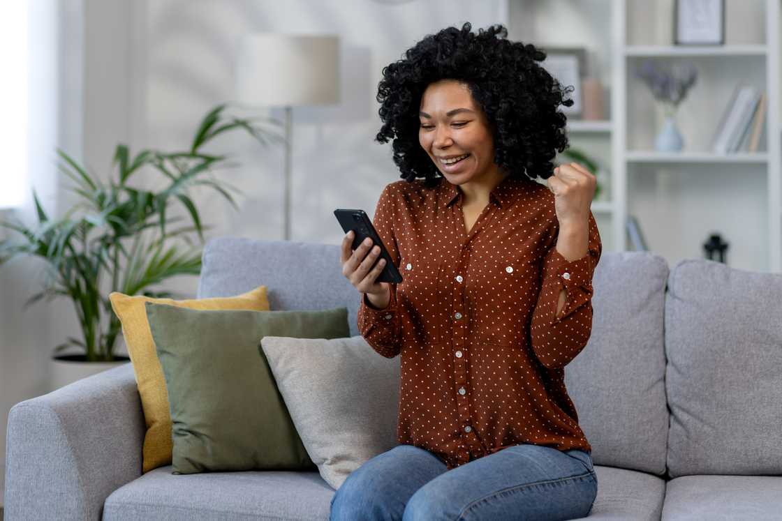 woman happy after receiving online notification