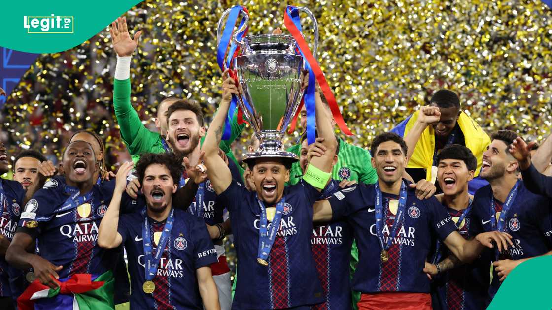 Marquinhos lifts the UEFA Champions League trophy after his team's victory against Arsenal. Photo by Carl Recine