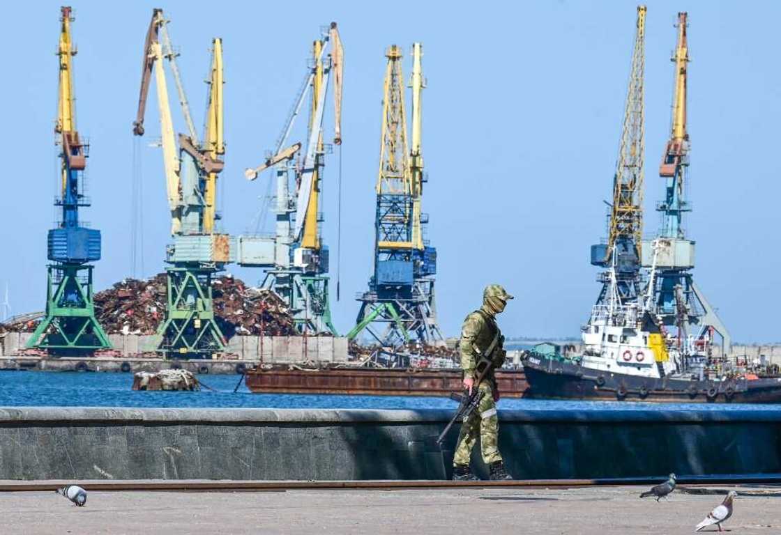 A Russian serviceman patrols on the promenade in Berdyansk in mid-June amid the ongoing Russian military action in Ukraine