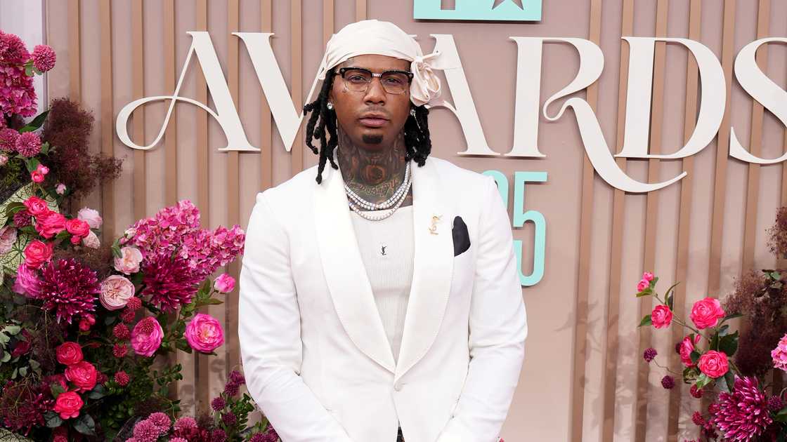 Moneybagg Yo poses in a white suit at the 2025 BET Awards at Peacock Theatre
